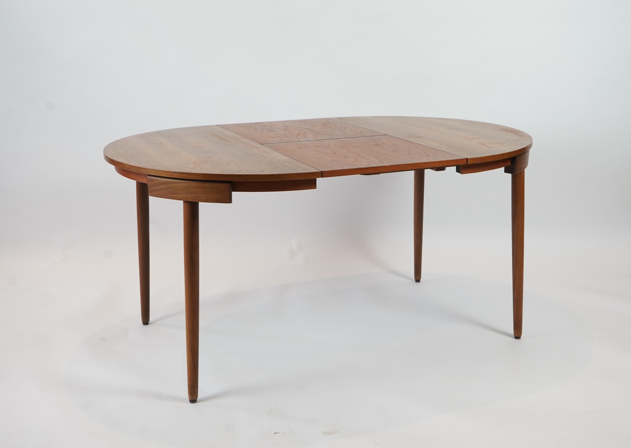 Hans Olsen (Danish, 1919–1992) for Frem Røjle: A Danish teak 'Roundette' extending dining table and four chairs